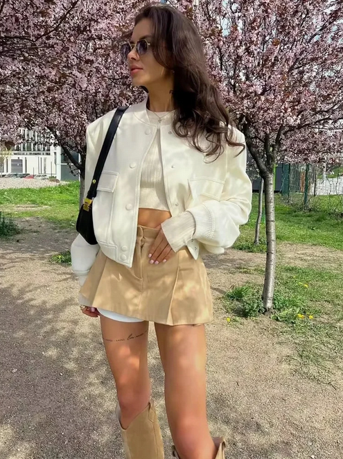 Beige pleated mini skirt with white inner shorts and cropped jacket